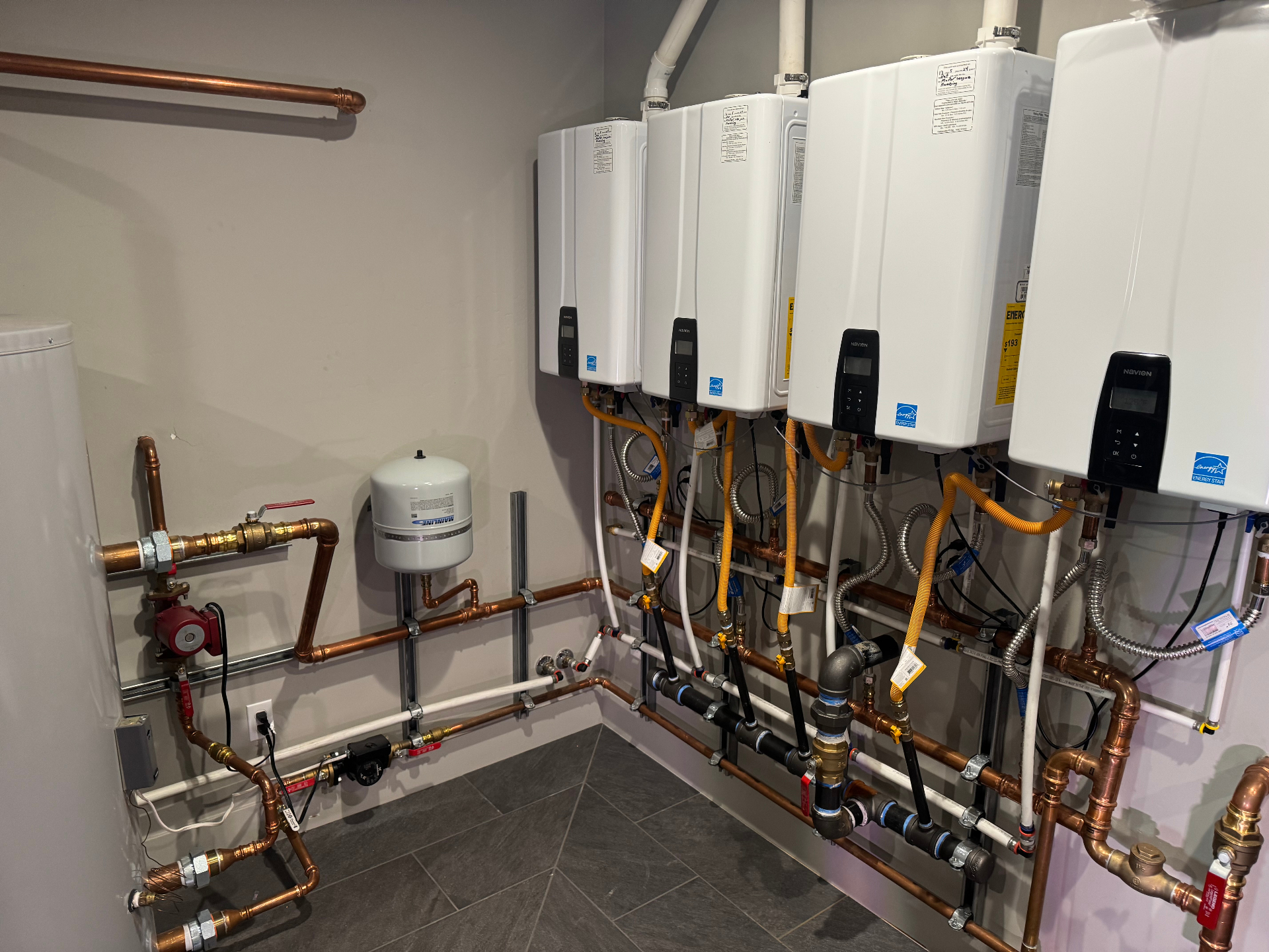 Multi-unit Navien tankless bank — commercial install